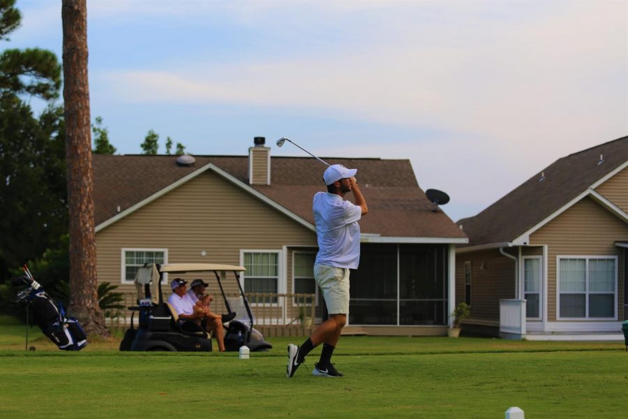 Varsity golfer Simon Dunn tees off