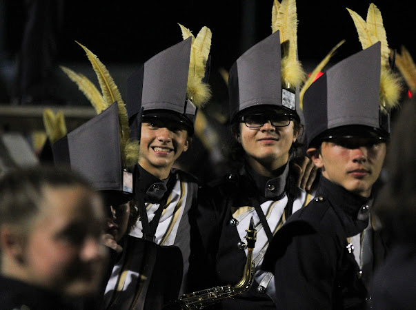 Above, members of the Soundwave Band smile as they prepare for the Homecoming halftime show