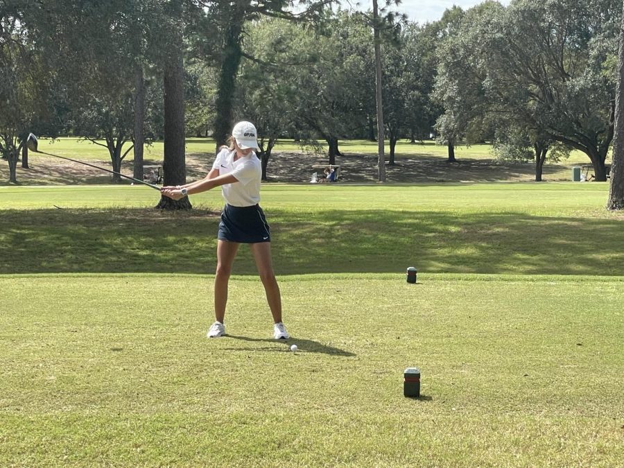 A member of the GBHS Girls Golf Team takes a swing during a competition