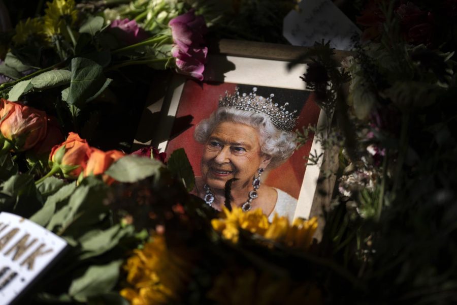 A+picture+commemorating+Queen+Elizabeth+is+displayed+among+flowers+at+her+funeral.