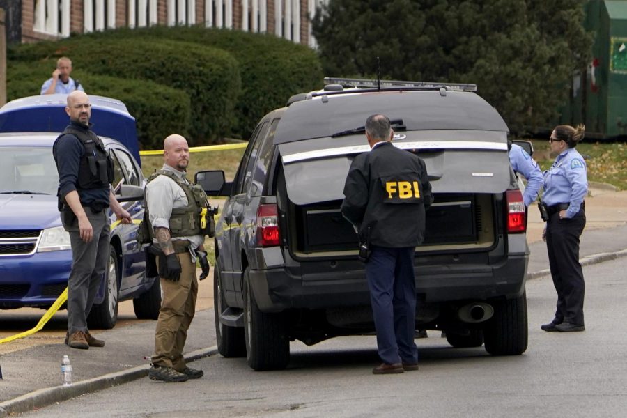 Police and FBI agents investigate the scene of the crime.