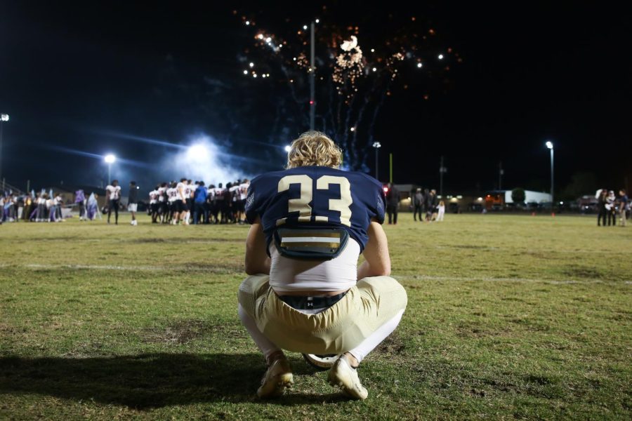 Player 33 kneels after a tough loss,