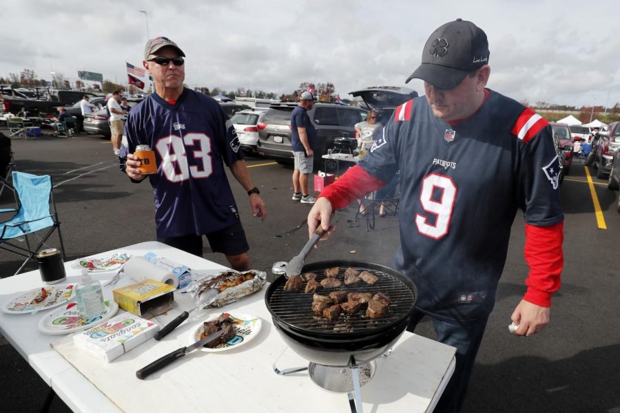 Patriots fans tailgate before a football game.