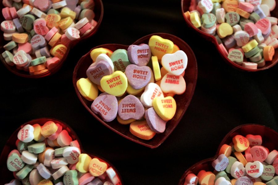 Candy hearts sit in a bowl.