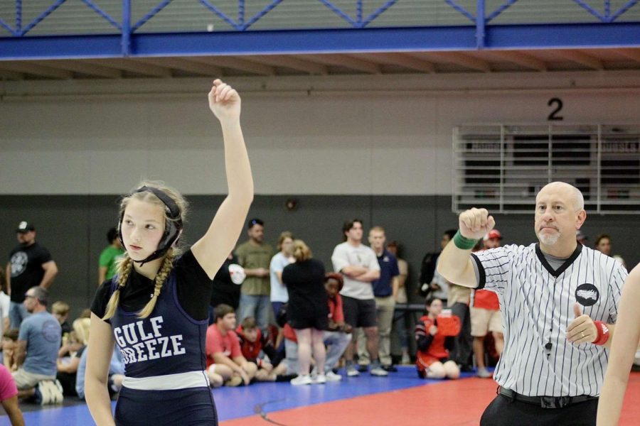 Powell stands with her hand in the air after beating an opponent.