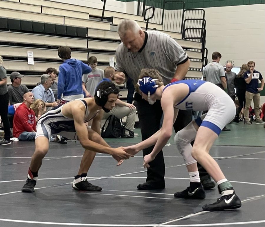 Dolphin wrestler faces off against an opponent at the district championship.