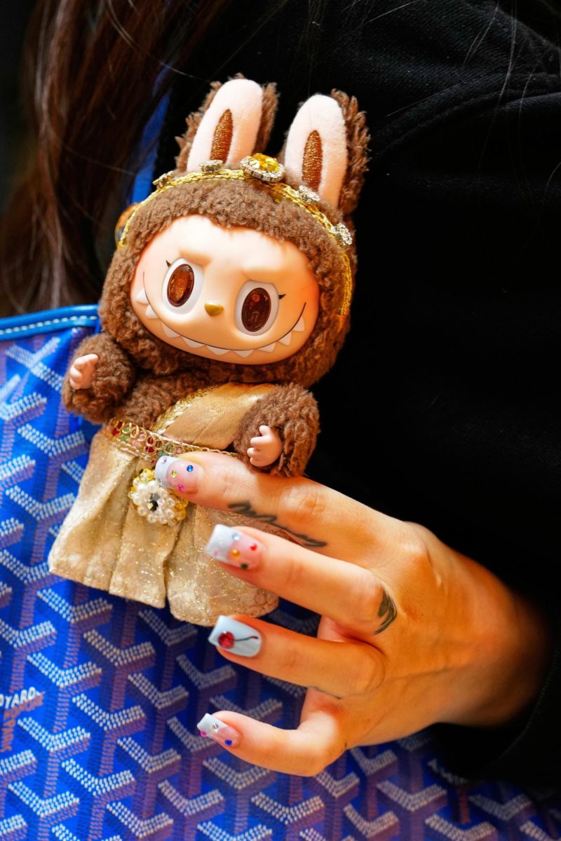 Diep Nguyen shows a Labubu doll to media during the opening of Germany's first shop for Labubu plush dolls in Berlin, July 25, 2025. (AP Photo/Markus Schreiber)