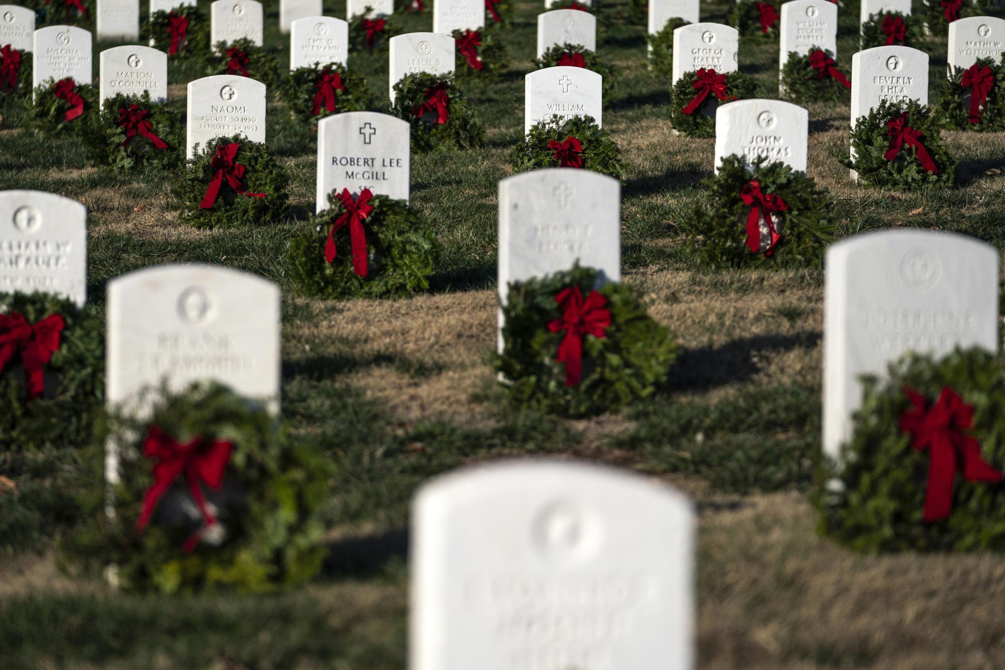 Grave markers are seen adorned with wreaths at Arlington National Cemetery during Wreaths Across America Day on Saturday, Dec. 14, 2024, in Arlington, Va. (AP Photo/Nathan Howard)