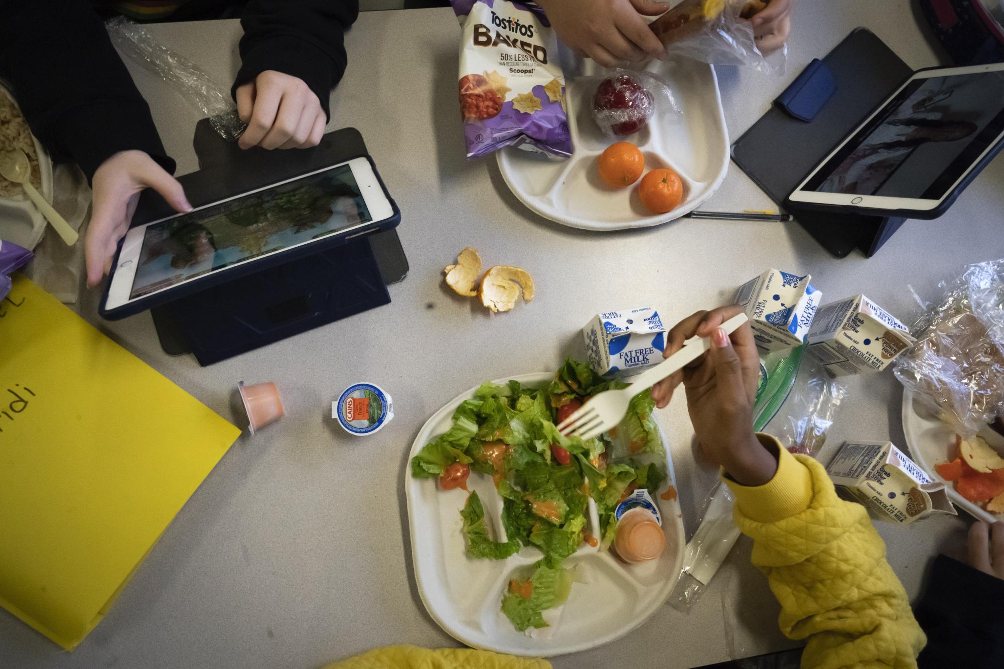  Seventh graders sit together in the cafeteria during their lunch break at a public school, Friday, Feb. 10, 2023, in the Brooklyn borough of New York. (AP Photo/Wong Maye-E)