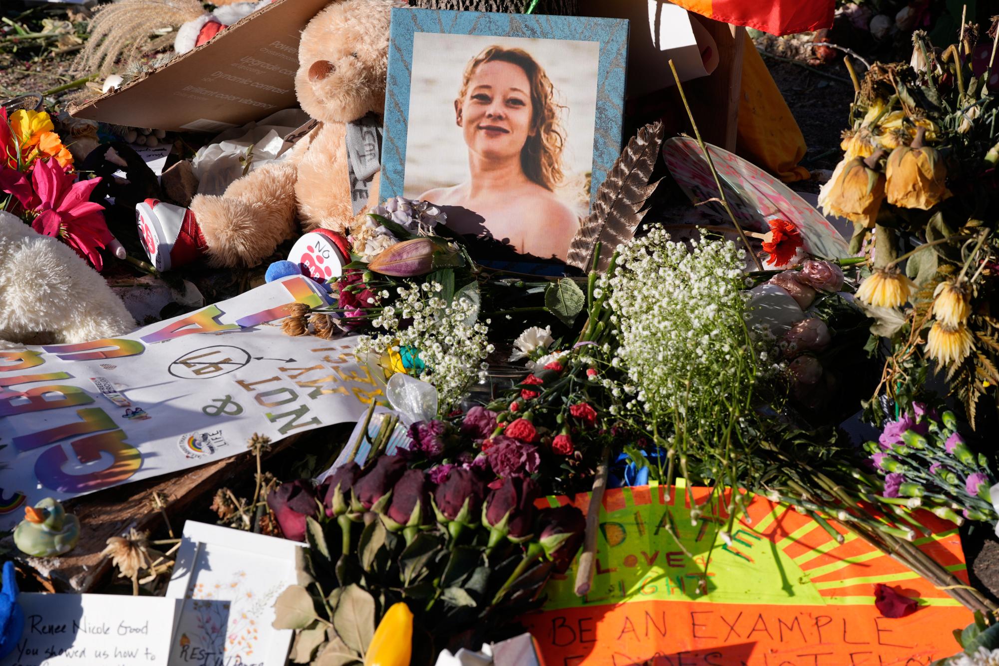 Flowers and photos are left at a memorial site for Renee Good on Saturday, Jan. 31, 2026, in Minneapolis. (AP Photo/Alex Brandon)
